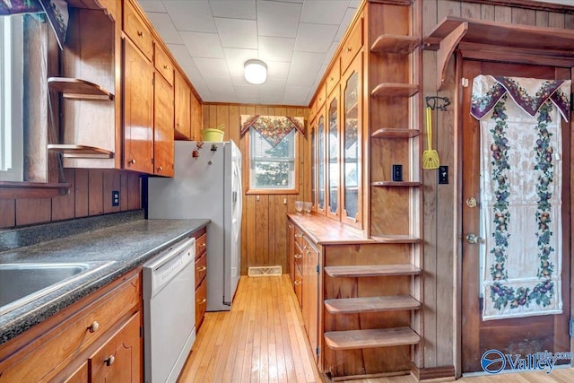104 Myrtle Pl, Stevenson, AL 35772 - kitchen featuring open shelves, white appliances, wooden walls, brown cabinets, and light wood-style flooring