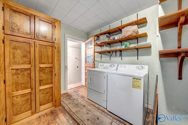 104 Myrtle Pl, Stevenson, AL 35772 - washroom with washer and dryer, cabinet space, and light wood-type flooring