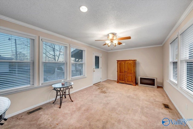 104 Myrtle Pl, Stevenson, AL 35772 - unfurnished living room featuring light carpet, a textured ceiling, ceiling fan, and ornamental molding