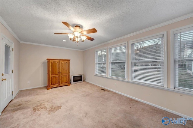 104 Myrtle Pl, Stevenson, AL 35772 - unfurnished living room with plenty of natural light, light colored carpet, a ceiling fan, ornamental molding, and a textured ceiling