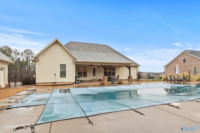 view of swimming pool featuring grilling area, a diving board, and a patio