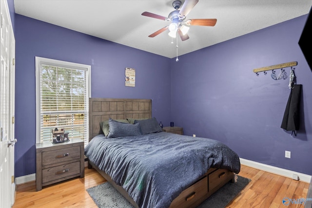 bedroom with ceiling fan and light hardwood / wood-style floors