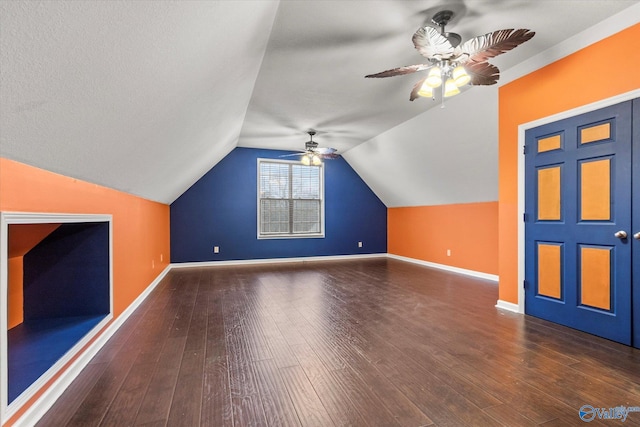 additional living space featuring ceiling fan, dark hardwood / wood-style flooring, and vaulted ceiling