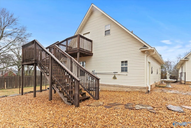 rear view of house featuring a wooden deck