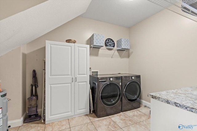 washroom with washer and clothes dryer and light tile patterned flooring