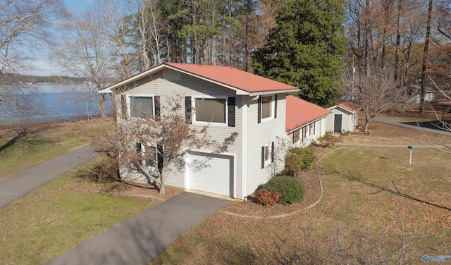 view of front of home featuring a water view and a garage