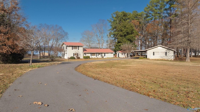 exterior space with a carport and a front lawn