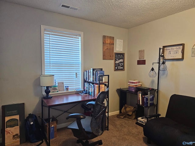 carpeted office with a textured ceiling