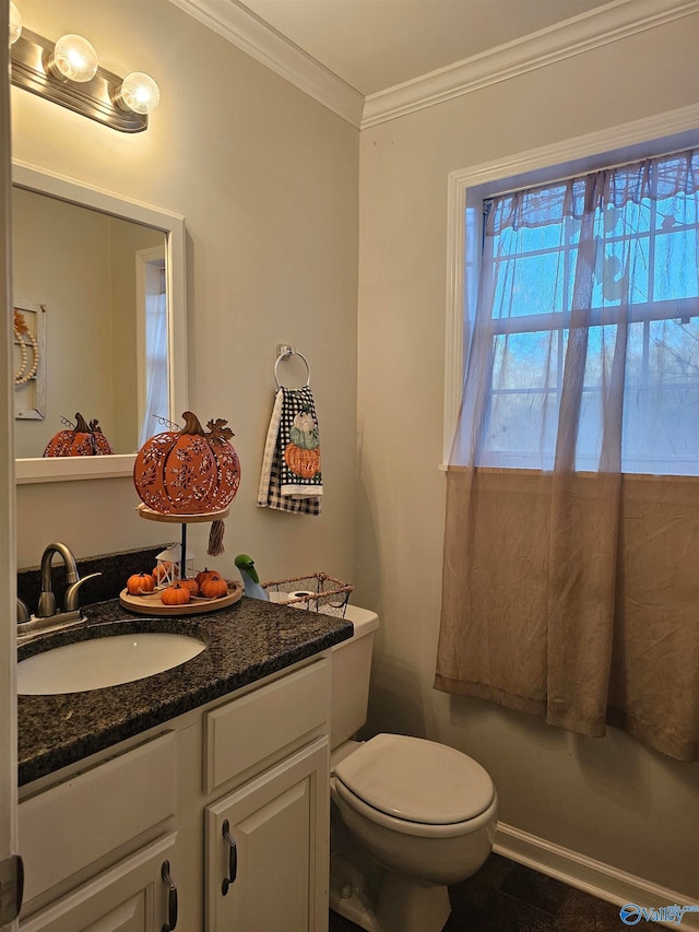 bathroom featuring vanity, toilet, and ornamental molding