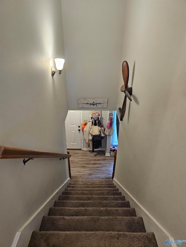 stairs featuring hardwood / wood-style floors