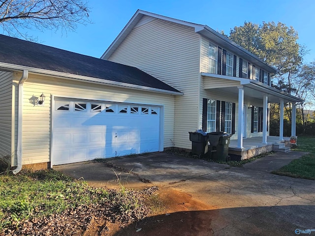 view of home's exterior with a porch and a garage