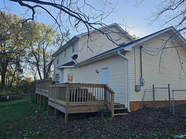 back of house with a deck