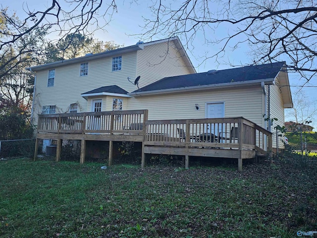 back of property featuring a yard and a wooden deck