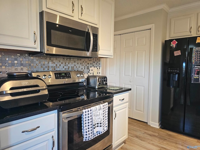 kitchen with white cabinetry, stainless steel appliances, and light hardwood / wood-style floors