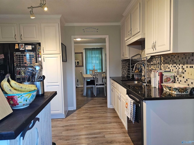 kitchen with backsplash, sink, black appliances, light hardwood / wood-style flooring, and white cabinetry