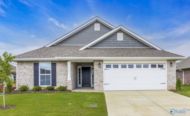 view of front of home with a front yard and a garage