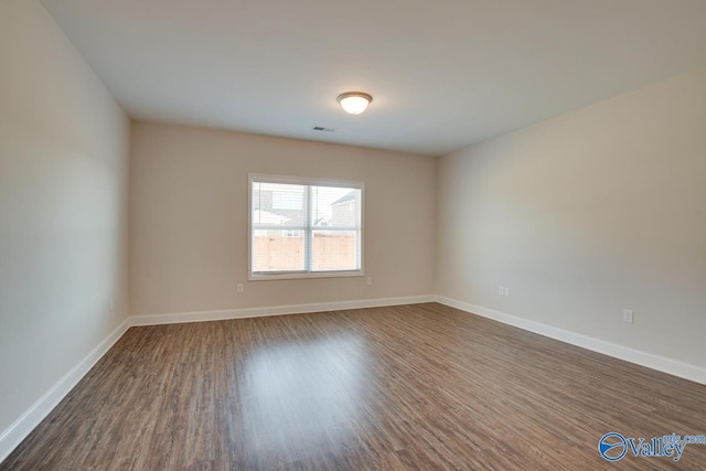 empty room featuring dark hardwood / wood-style floors