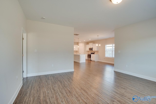 spare room with dark hardwood / wood-style floors