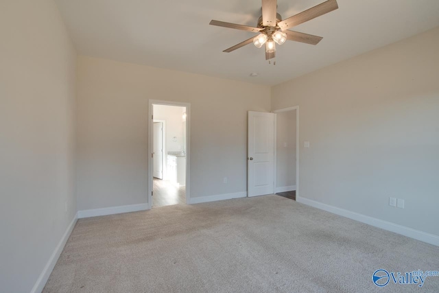 carpeted empty room featuring ceiling fan