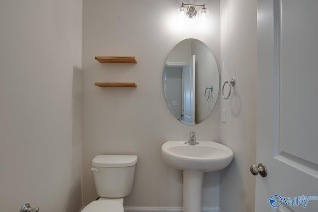 bathroom featuring sink and toilet