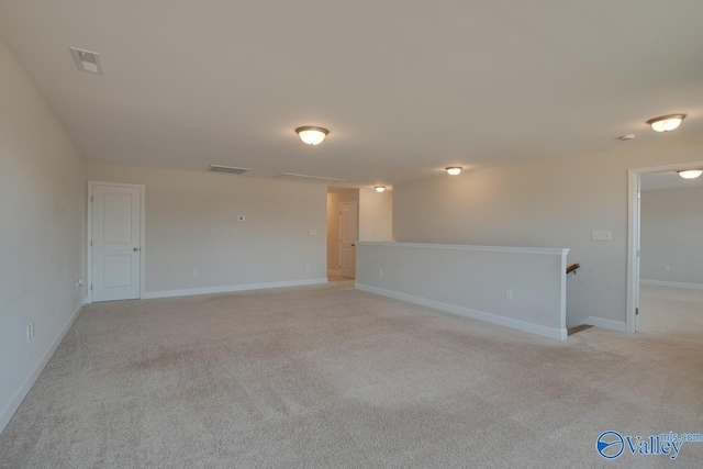 unfurnished room with light colored carpet