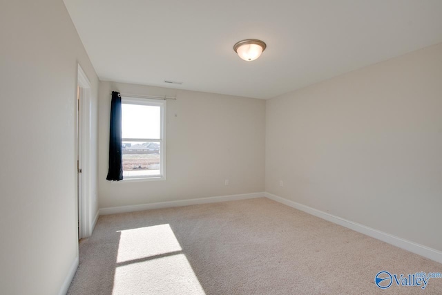 unfurnished room featuring light colored carpet