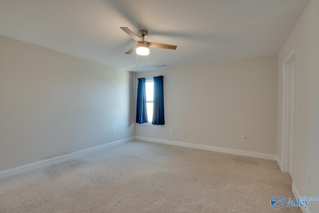 empty room featuring light carpet and ceiling fan