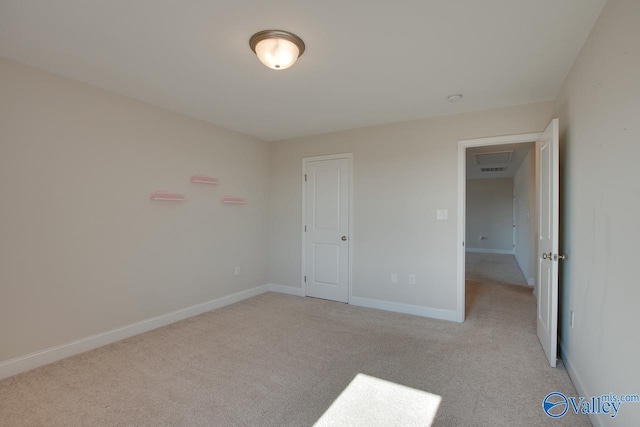 unfurnished bedroom featuring light colored carpet