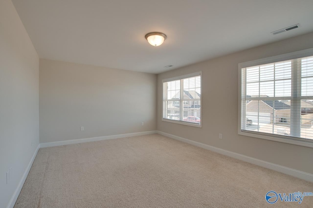 empty room featuring light carpet