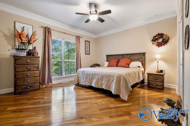 bedroom with ornamental molding, ceiling fan, and hardwood / wood-style floors