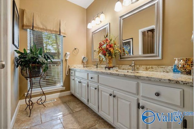 bathroom with double vanity and tile patterned floors