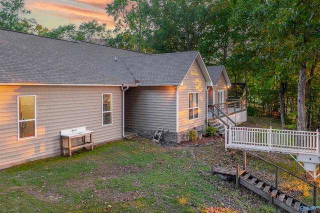 exterior space featuring a wooden deck and a yard