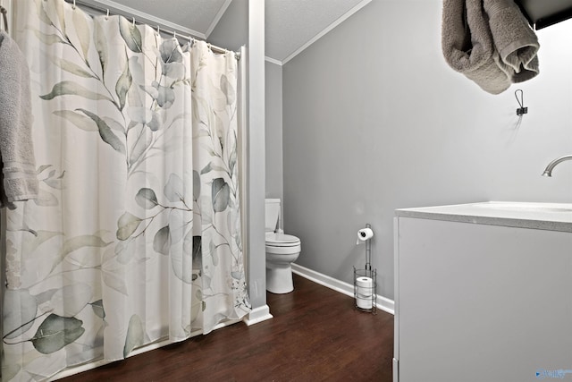 bathroom featuring a textured ceiling, crown molding, sink, hardwood / wood-style floors, and toilet