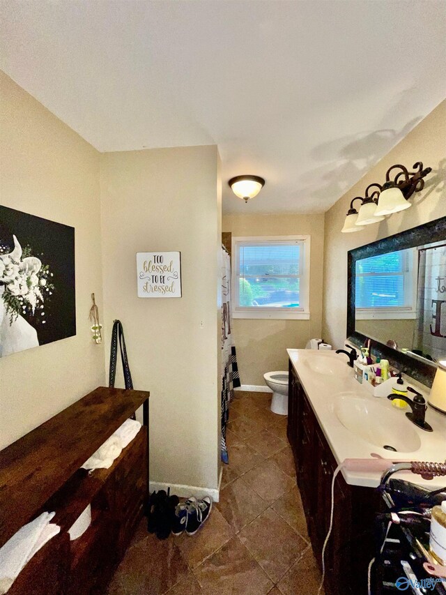 bathroom featuring a shower with shower curtain, tile patterned flooring, toilet, and vanity