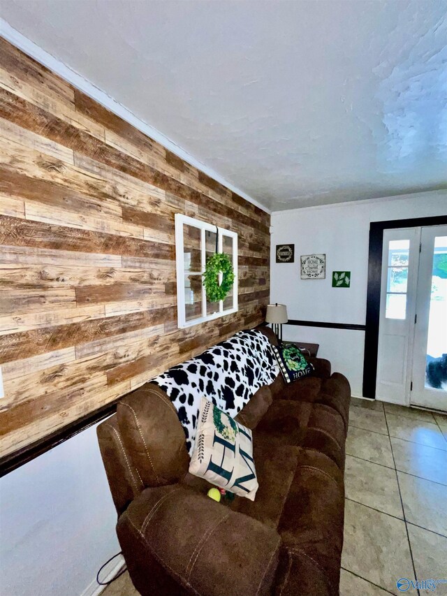 living room with wooden walls and tile patterned flooring