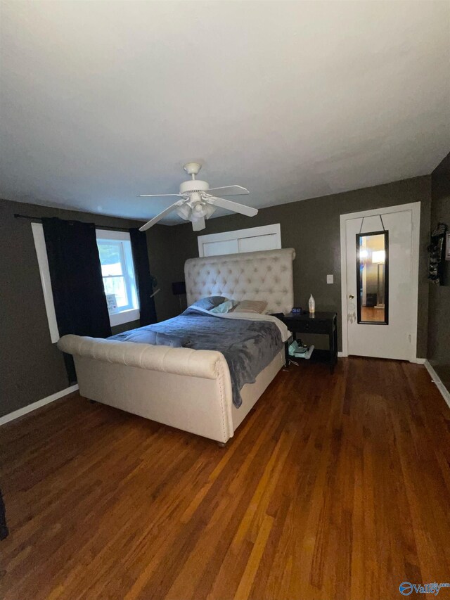 unfurnished bedroom with ceiling fan and dark hardwood / wood-style flooring