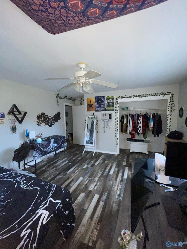 interior space featuring dark wood-type flooring and ceiling fan