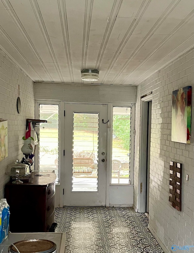 doorway with french doors and brick wall