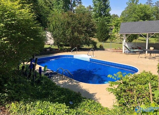 view of pool featuring a patio and a gazebo