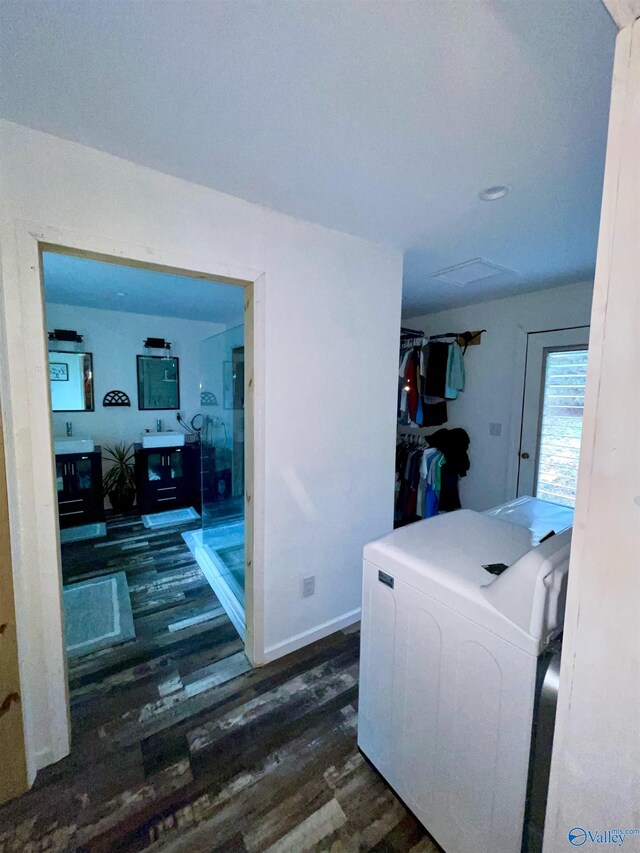 laundry area with dark hardwood / wood-style flooring and washer / dryer