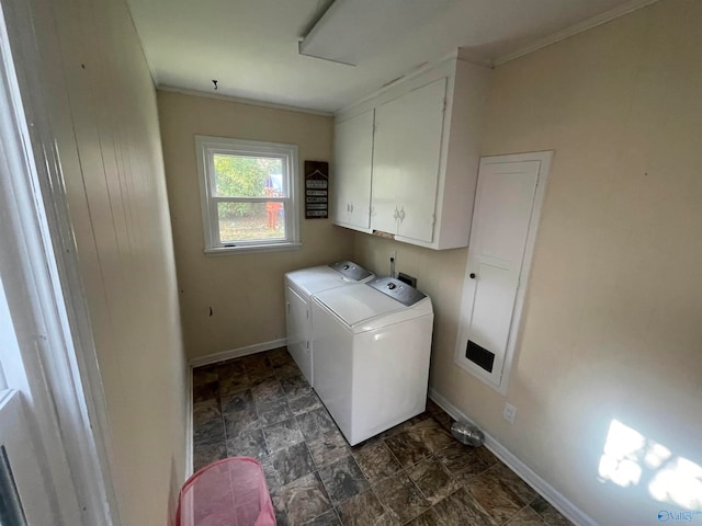 laundry room with washer and dryer, crown molding, and cabinets