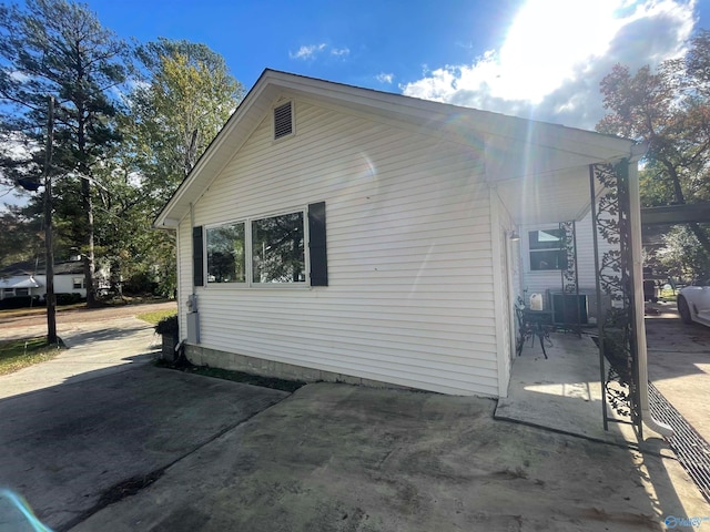 view of property exterior with a patio area