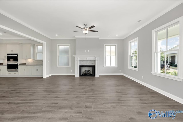 unfurnished living room with crown molding, ceiling fan, and hardwood / wood-style floors