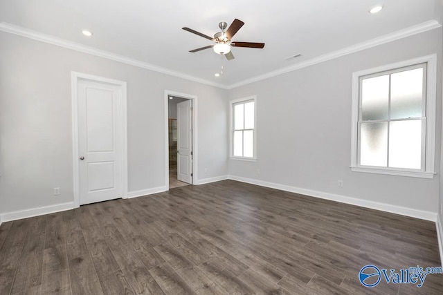 empty room featuring dark wood-type flooring, ceiling fan, and ornamental molding