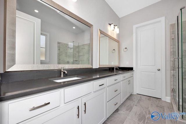 bathroom featuring vanity and an enclosed shower