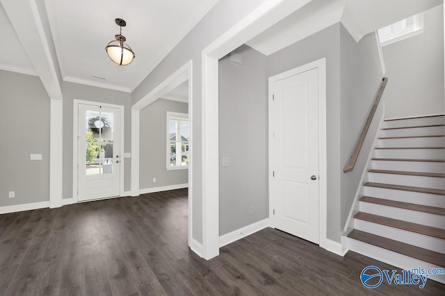 foyer featuring crown molding and dark hardwood / wood-style floors