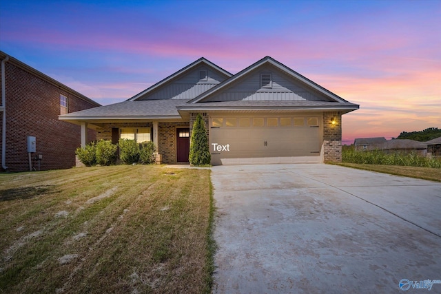 view of front of home featuring a garage and a yard