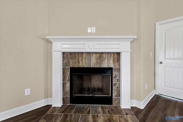 room details with wood-type flooring and a tile fireplace