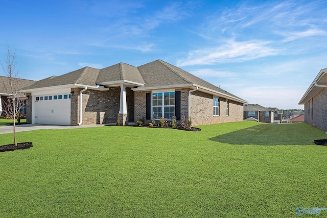 view of front of property with a front lawn, an attached garage, and brick siding