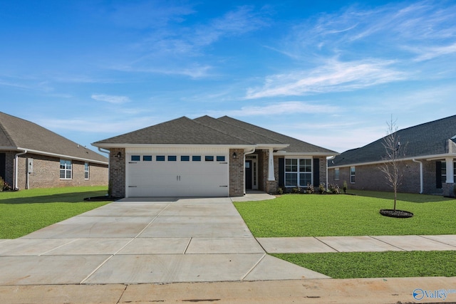 view of front of property featuring a garage, concrete driveway, a front lawn, and brick siding